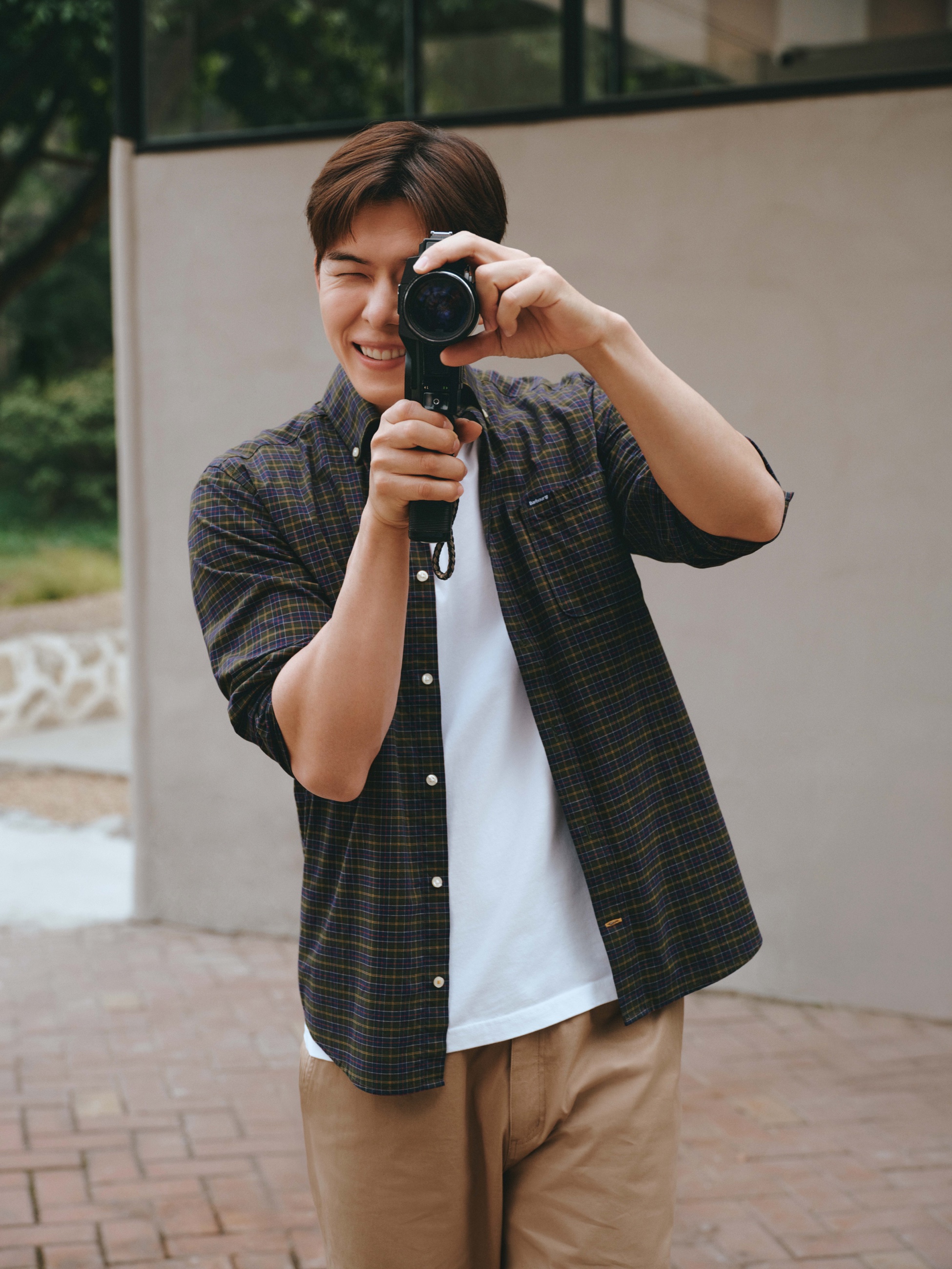 Barbour SS26 man filming with a camera