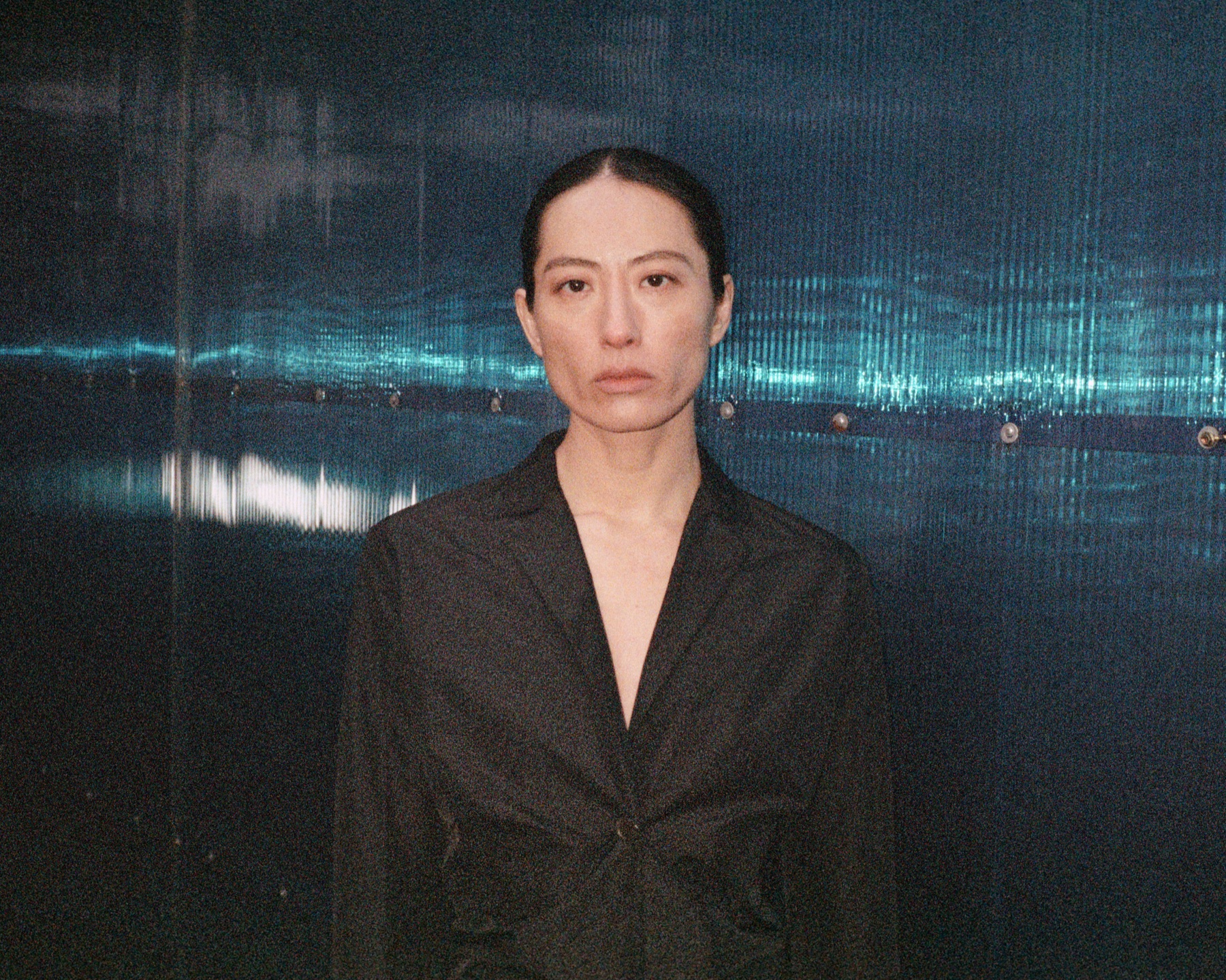 Jil Sander Lunar New Year campaign portrait against a reflective interior