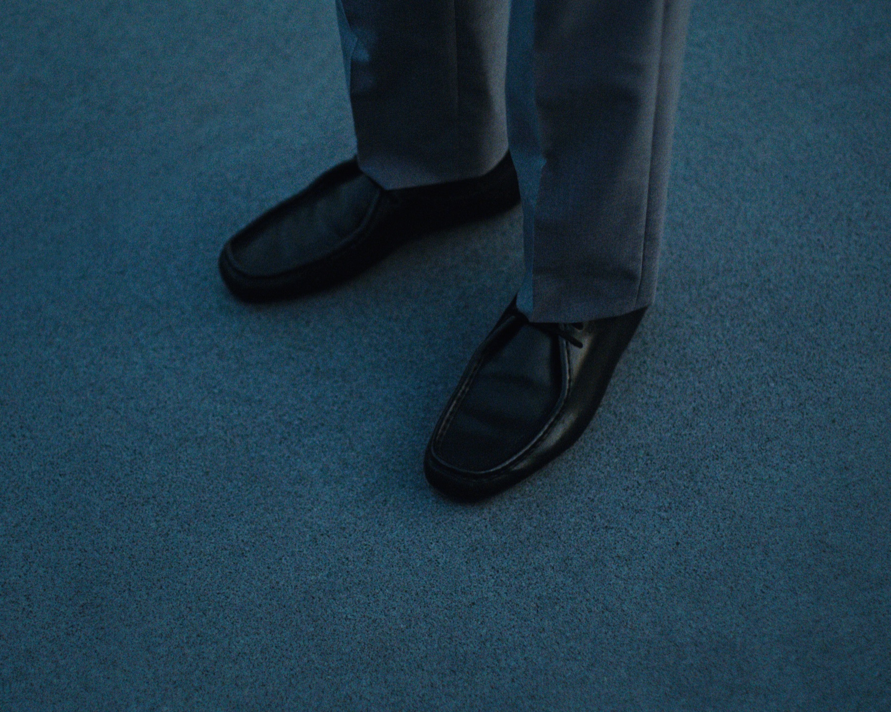Jil Sander black shoes in the campaign's blue-toned setting