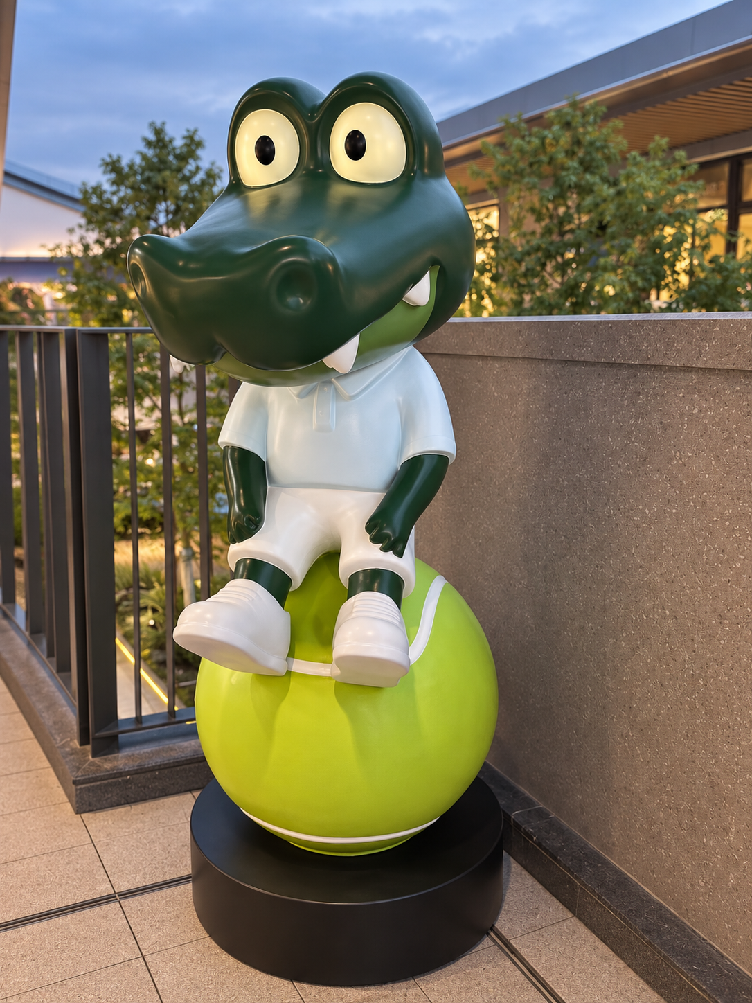 Codi sculpture seated on a tennis ball