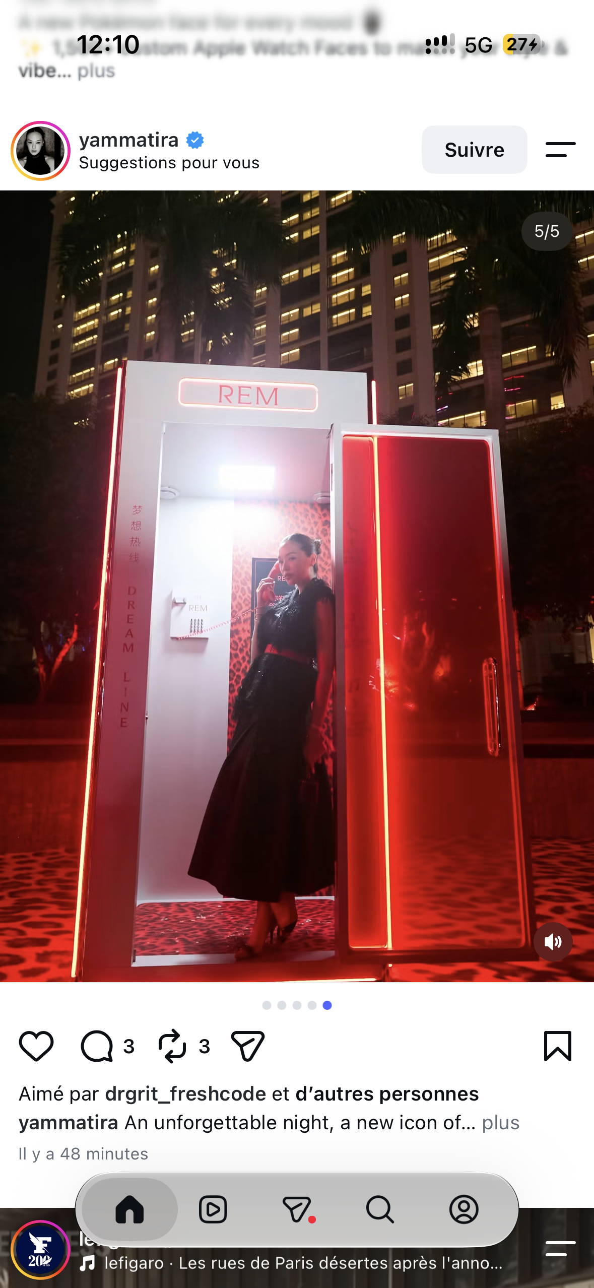 A guest in a long black dress inside the illuminated red Dream Line booth