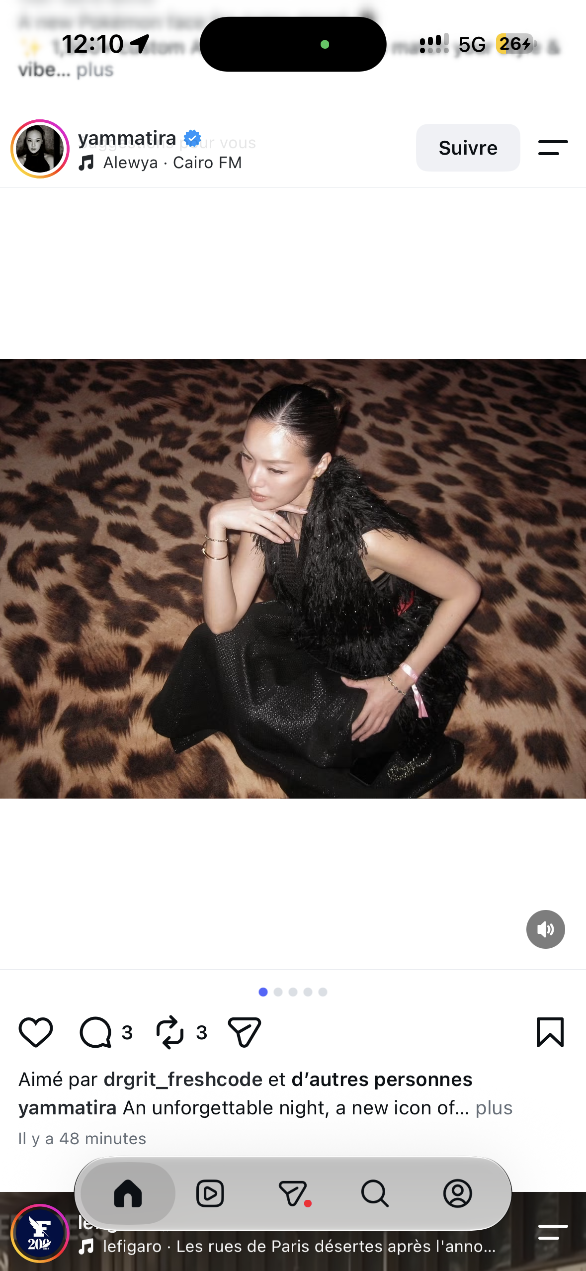 A guest in a black feathered dress seated against leopard print