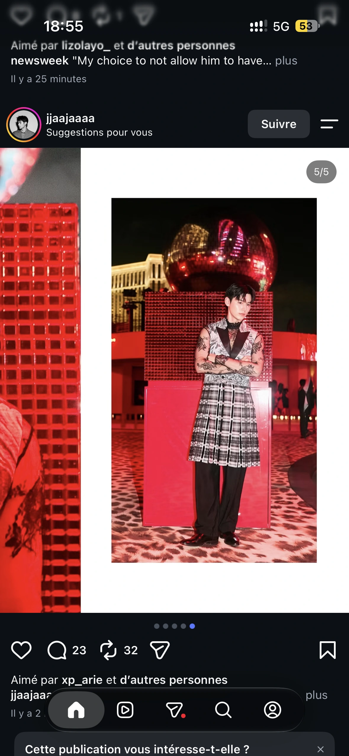 A full-length guest portrait in lace and a patterned vest beneath the red mirrored disco ball