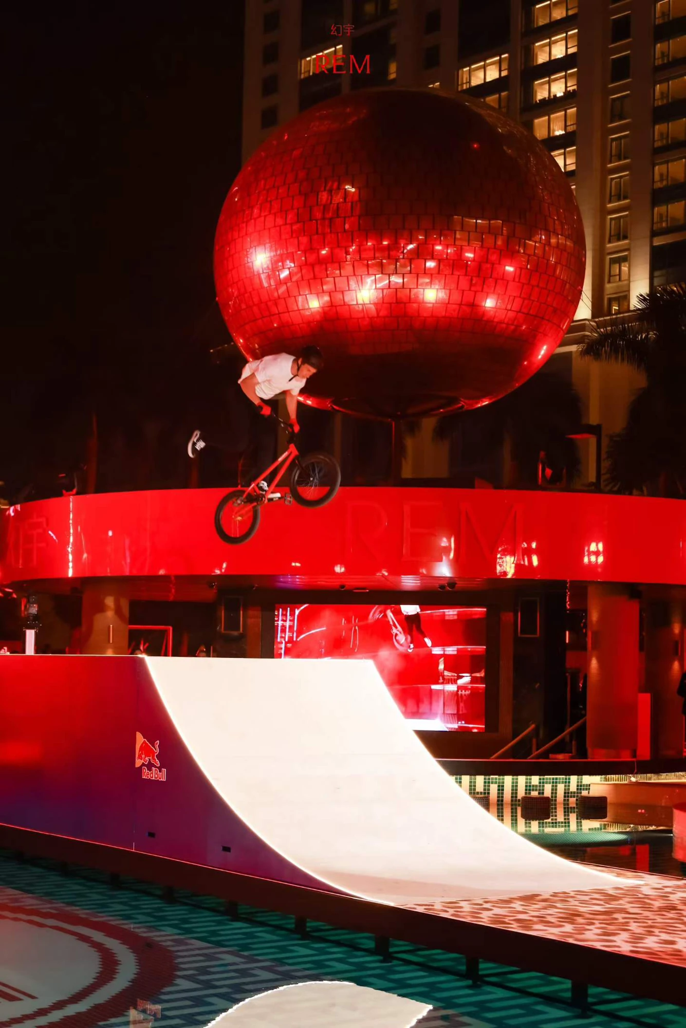 A BMX rider performs beneath the disco ball