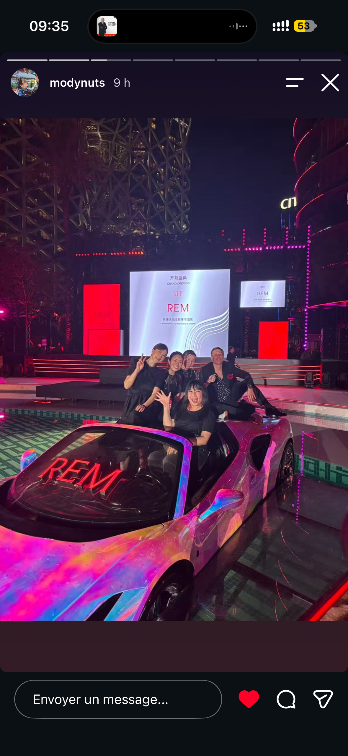 Five guests celebrating together in the iridescent REM car floating in the pool