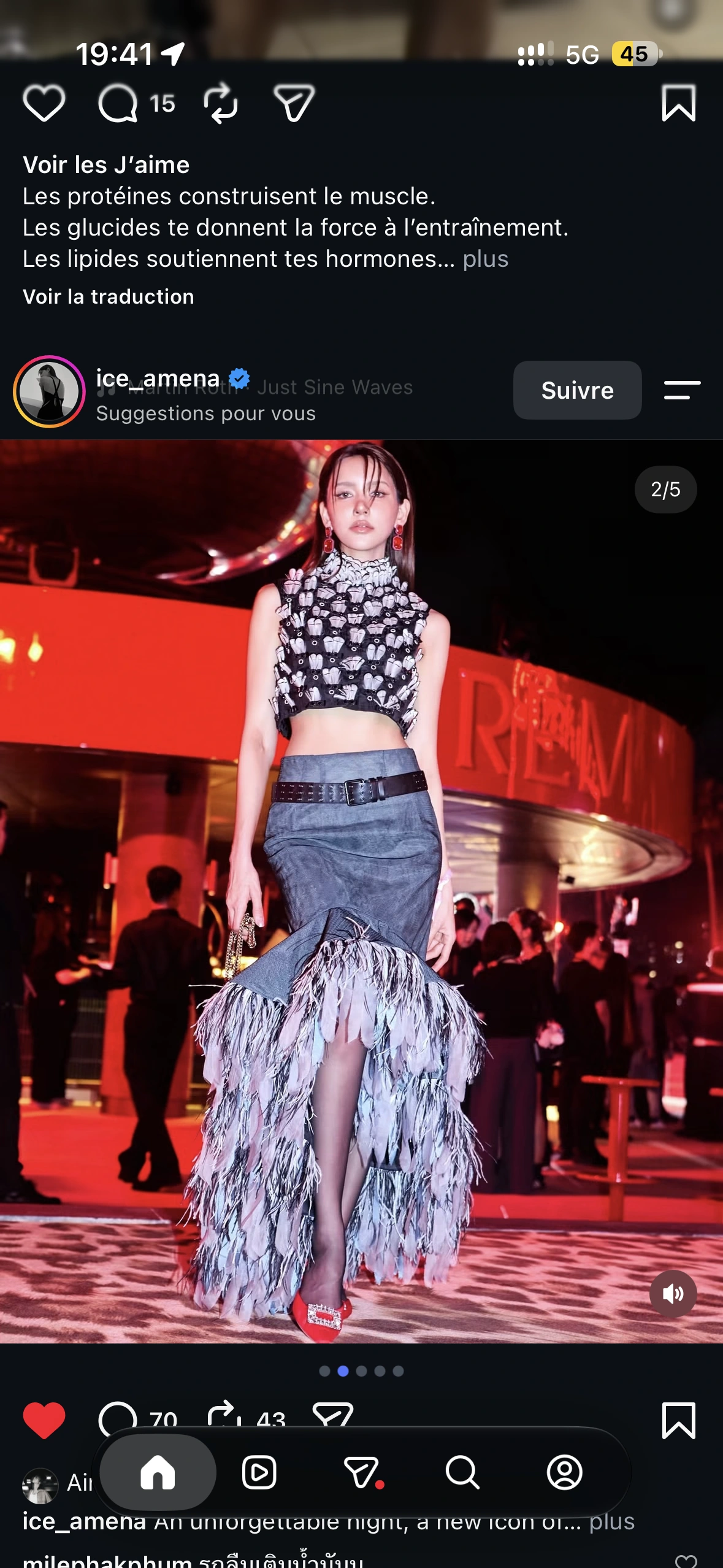 A guest in a patterned top and long fringed skirt with red shoes beneath the mirrored disco ball