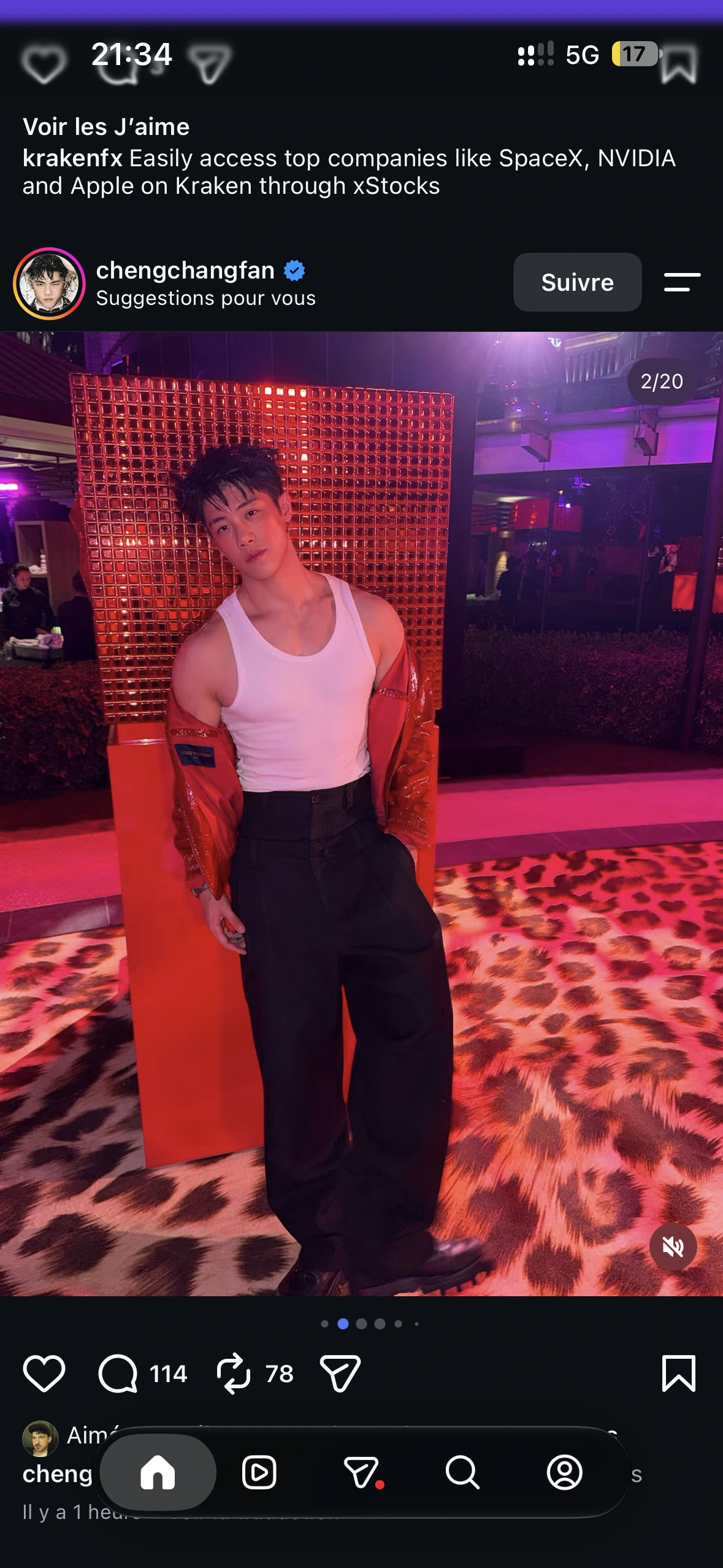 A guest in a red jacket and white vest against a mirrored red installation and leopard-print carpet