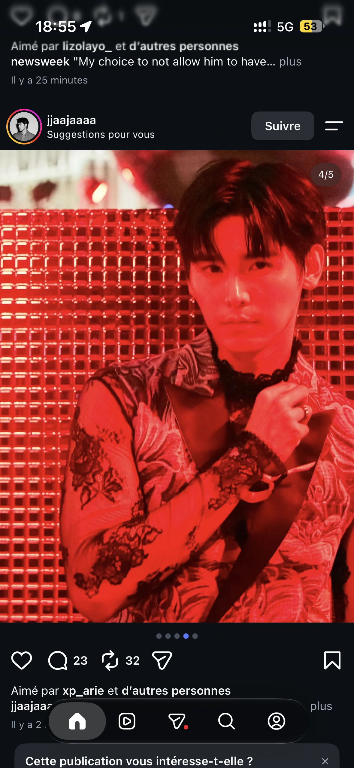 A close-up guest portrait in a lace shirt against a red reflective backdrop