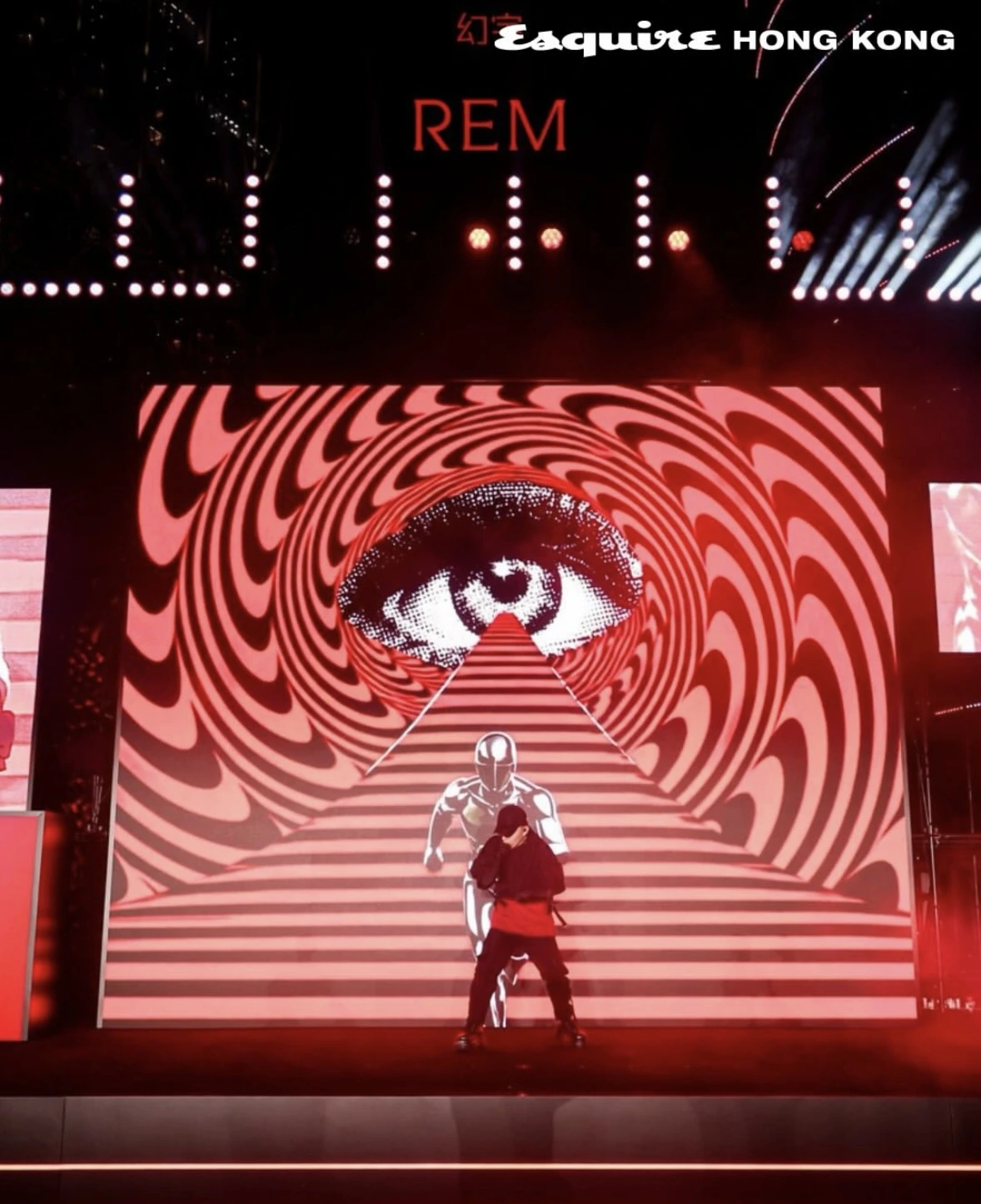 Surreal red eye and stairway video content on the stage during a live performance