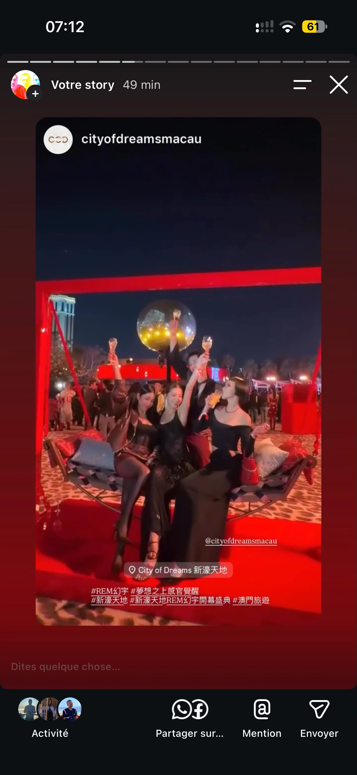 Friends raising their glasses together on the suspended poolside swing