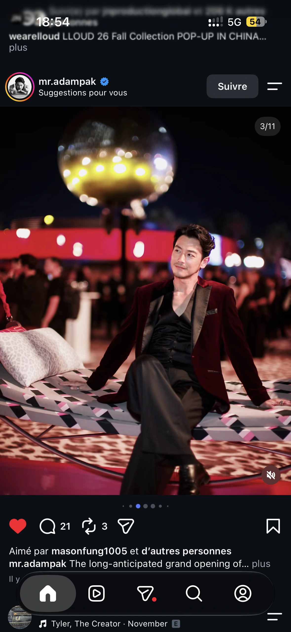A guest in a burgundy jacket seated on the patterned swing beneath the mirrored disco ball